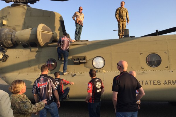 nhra drivers touring a military chinook helicopter