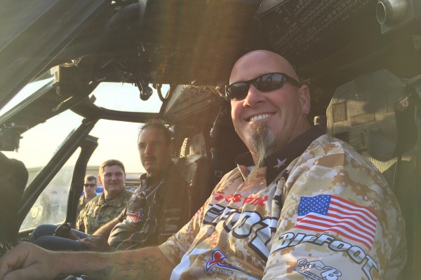men in cockpit of military helicopter