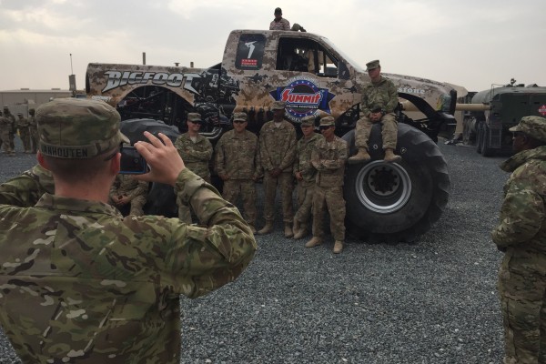 military troops with bigfoot monster truck