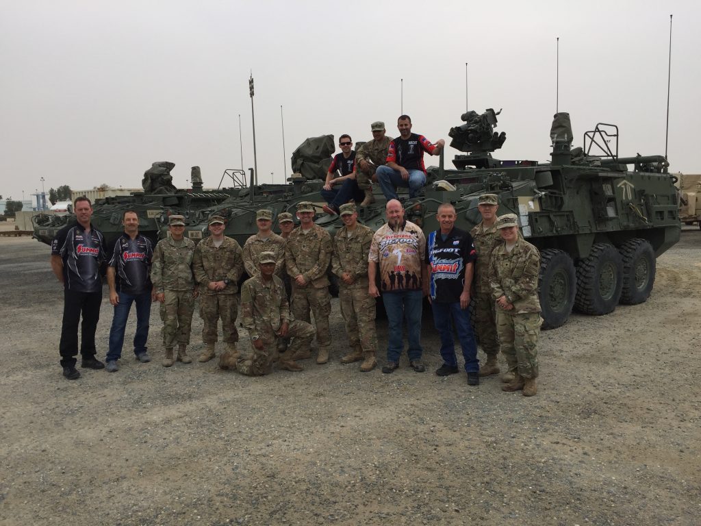 group of folks posing at military base