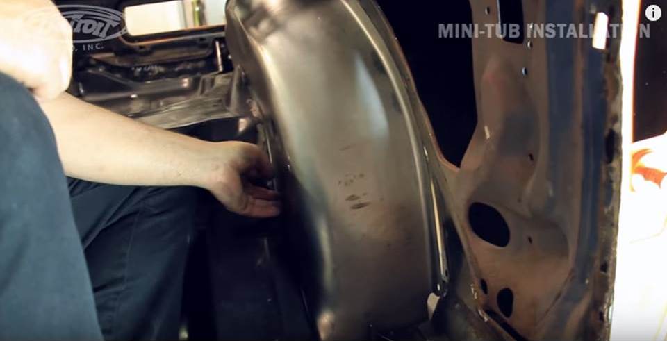 man installing detroit speed mini wheel tubs
