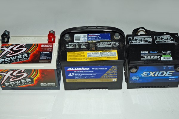 three automotive car batteries in a row