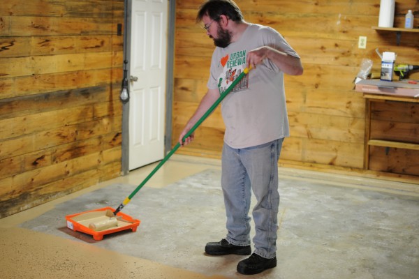 man painting garage floor