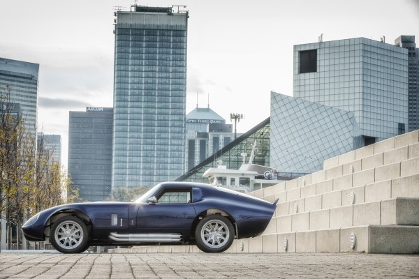 side profile of factory five daytona coupe in cityscape