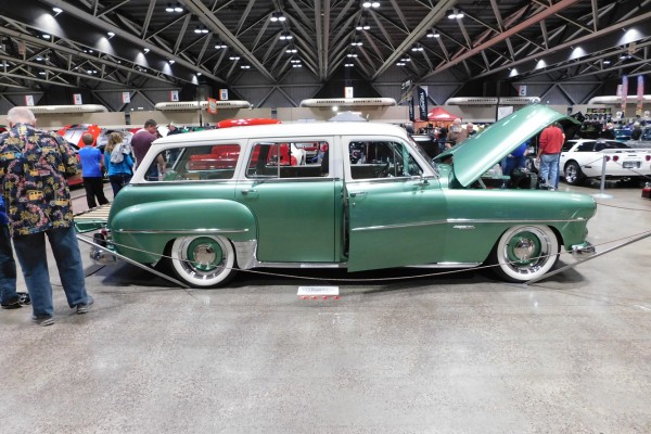 side profile view of a vintage station wagon at an indoor car show