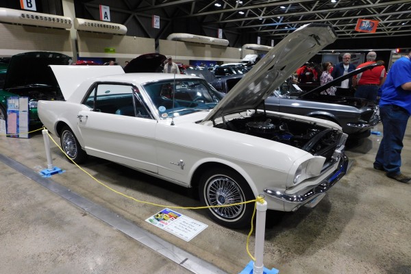 white first gen ford mustang notchback at car show