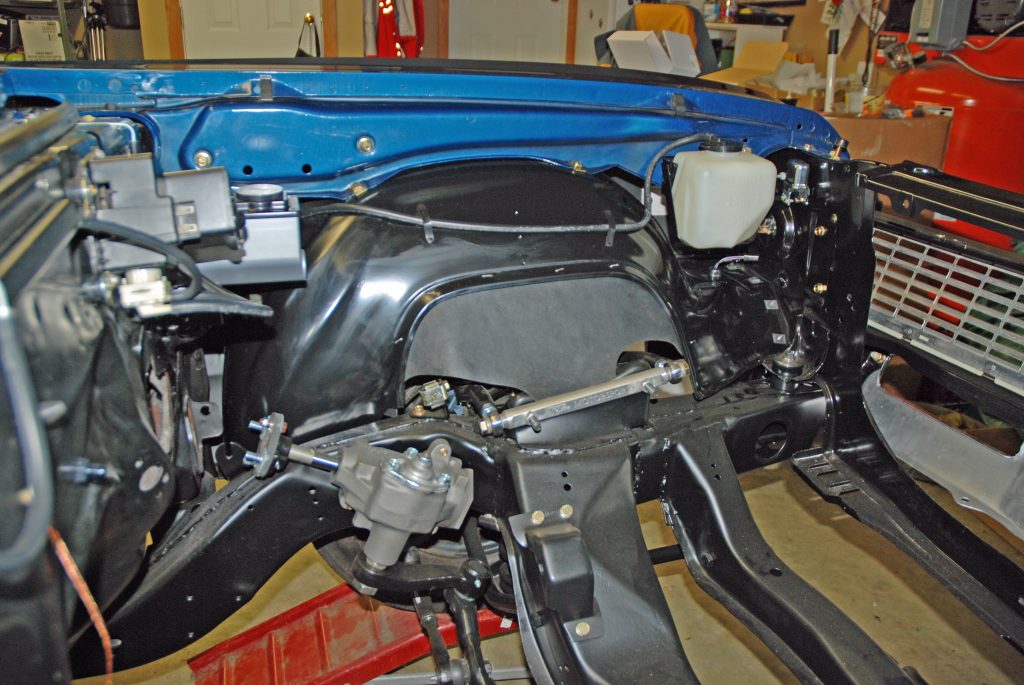 inside of an engine bay with engine removed