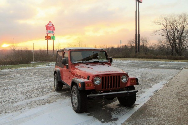 jeep wrangler lj tj at sunset, covered in light snow