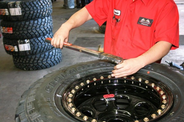 man installing tire on a beadlock rim