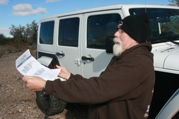 man reading instructions near jeep