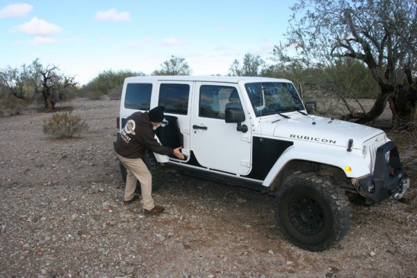 man adding side armor panels to jeep wrangler