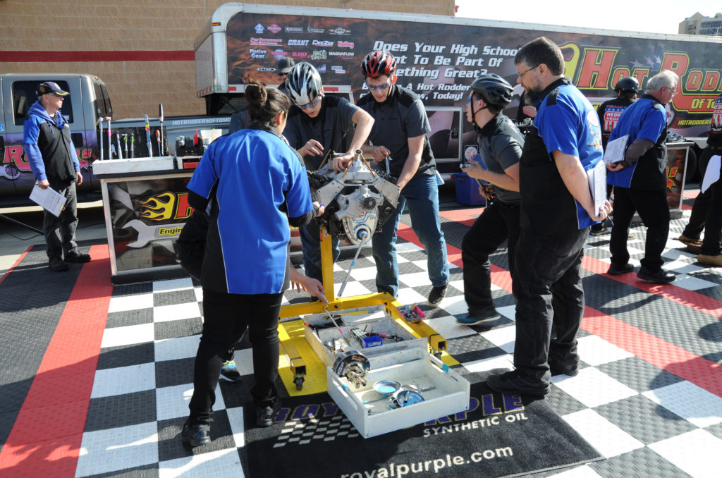 a group of teenagers in an engine building competition