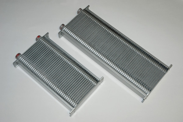 a pair of fluid, transmission, and oil coolers on a workbench