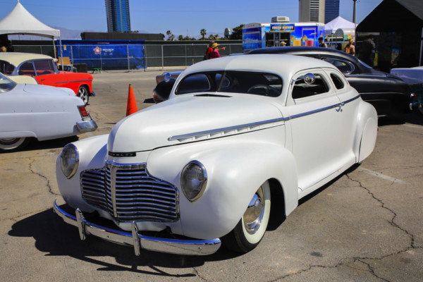 white mercury hot rod coupe at a car show