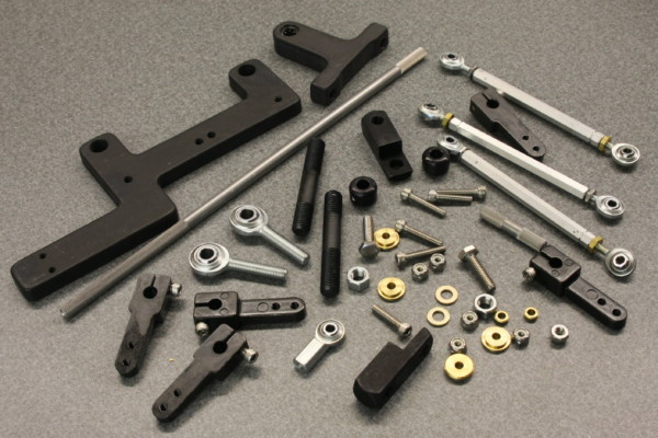 various brackets and hardware laying on a workbench