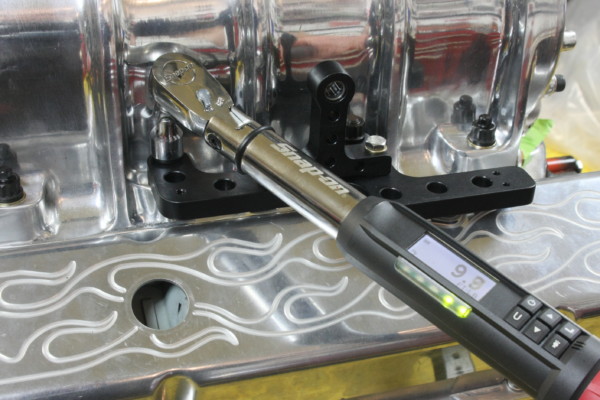 using a torque wrench on a throttle bracket