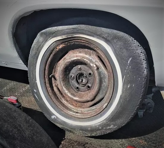 old flat ruined tire on a project car