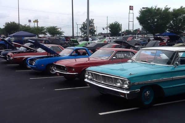 row of vintage ford cars at car show