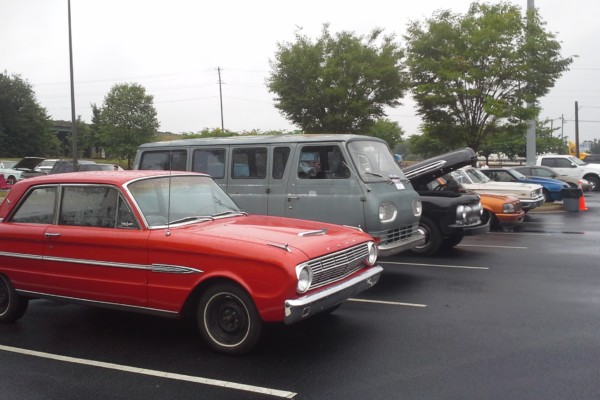 row of vintage ford cars and trucks at car show