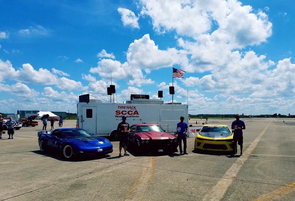 group of race cars and drivers at autocross winner circle