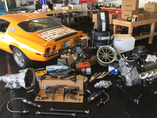 ridetech 48 hour camaro with parts in a garage