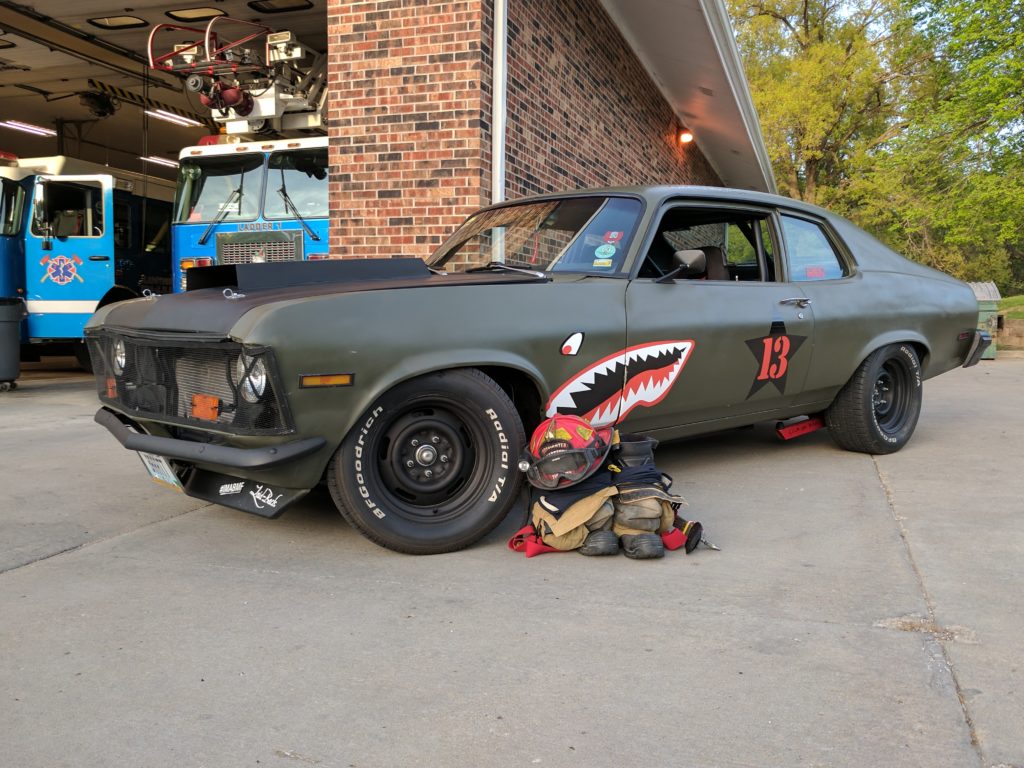 1974 chevy nova in flying tigers livery in front of a fire house