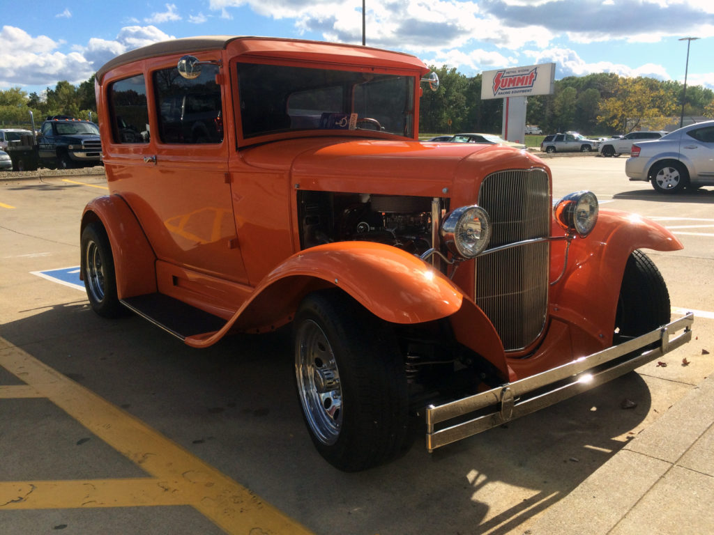 front passenger side shot of a orange 1931 ford model a hot rod at summit racing parking lot