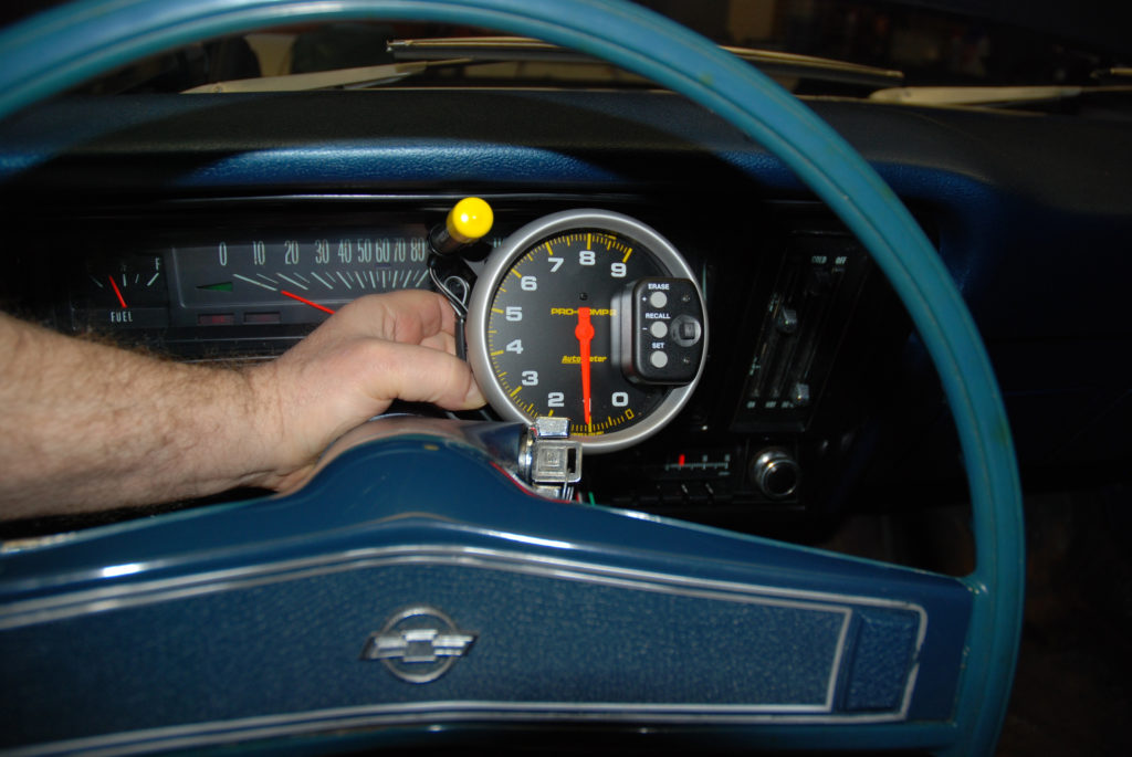 test fitting a pro comp tachometer in a vintage chevy muscle car