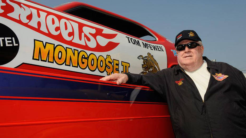 NHRA Driver Tom "The Mongoose" McEwen next to hot wheels funny car