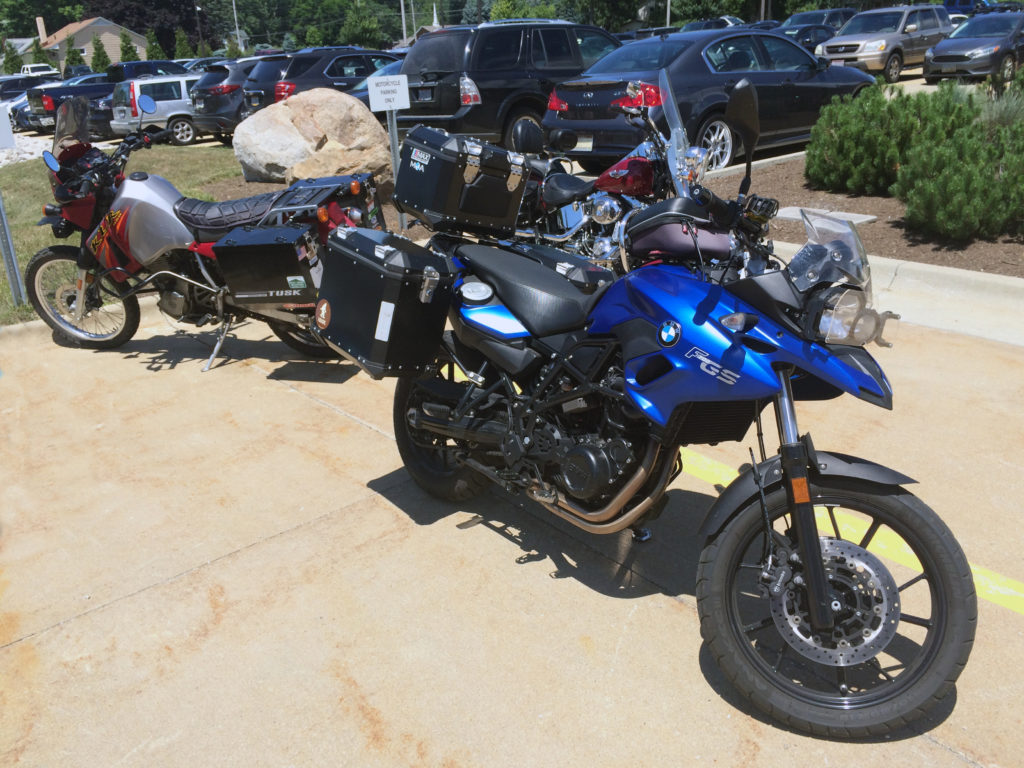 BMW and KLR Motorcycles in parking lot