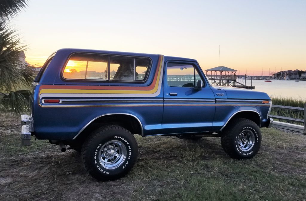 classic second gen ford bronco parked near a harbor