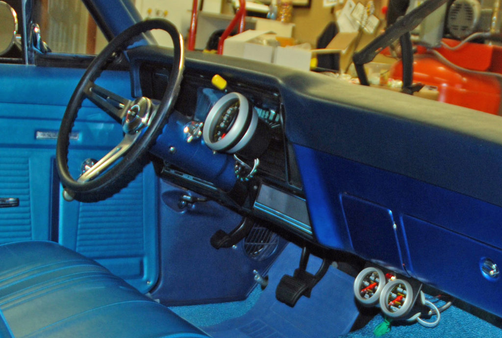 interior of a vintage nova muscle car with aftermarket gauges