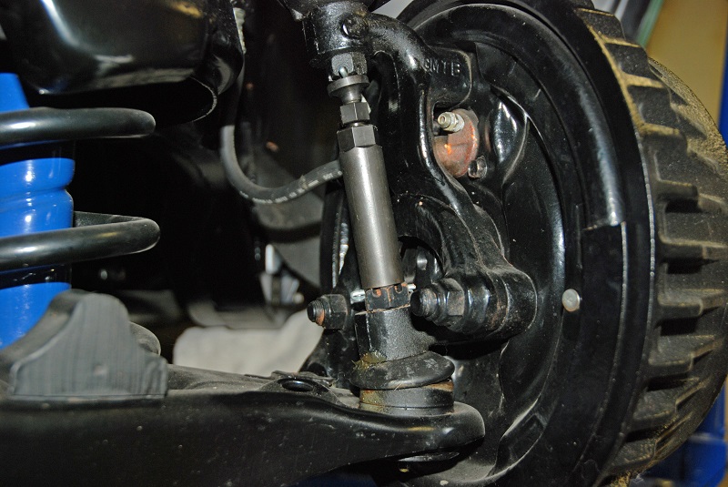 close up of a ball joint behind a brake drum