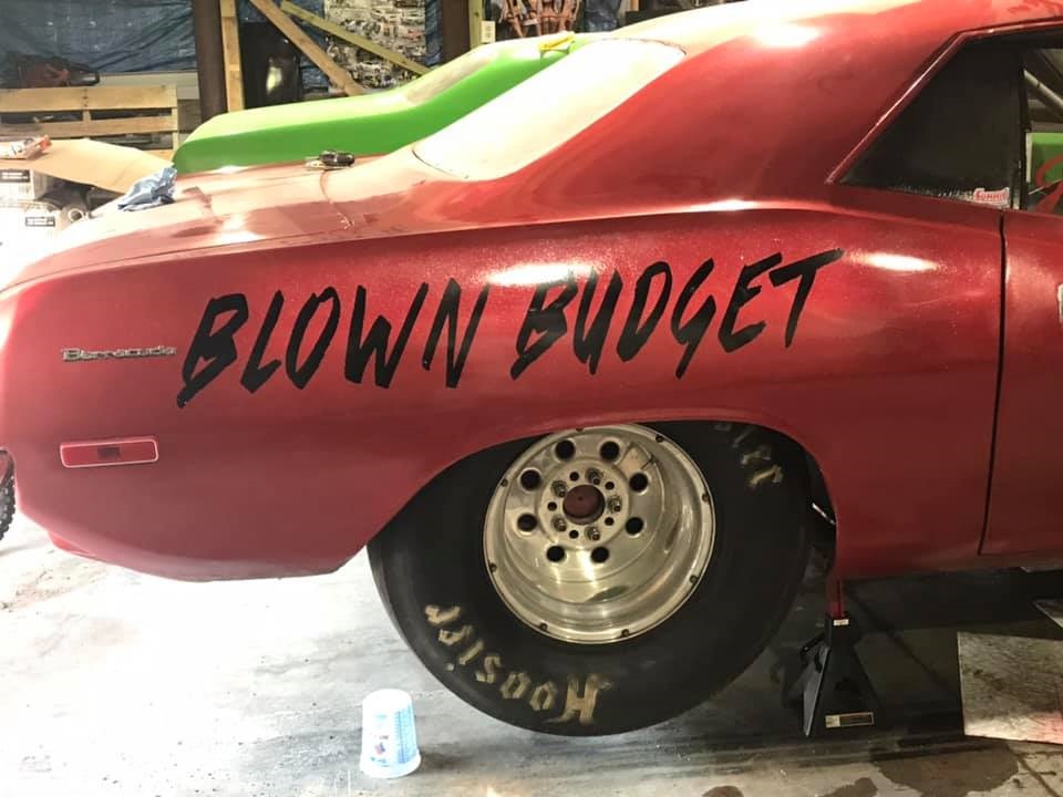 rear quarter shot of blown budget 1973 plymouth barracuda drag car