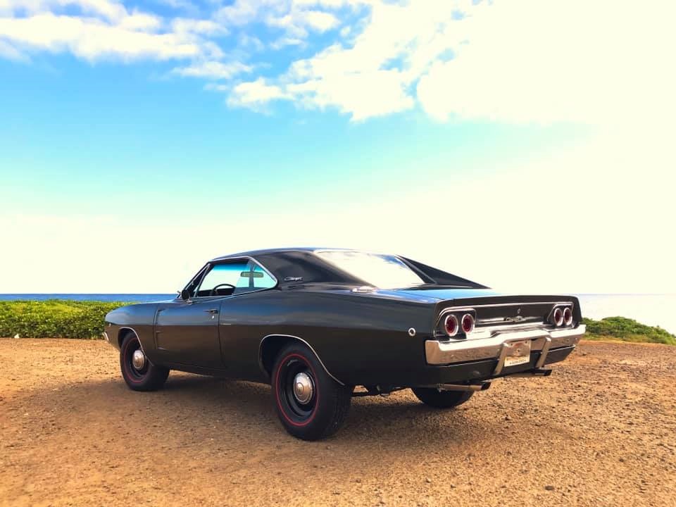 1968 dodge charger parked in front of ocean