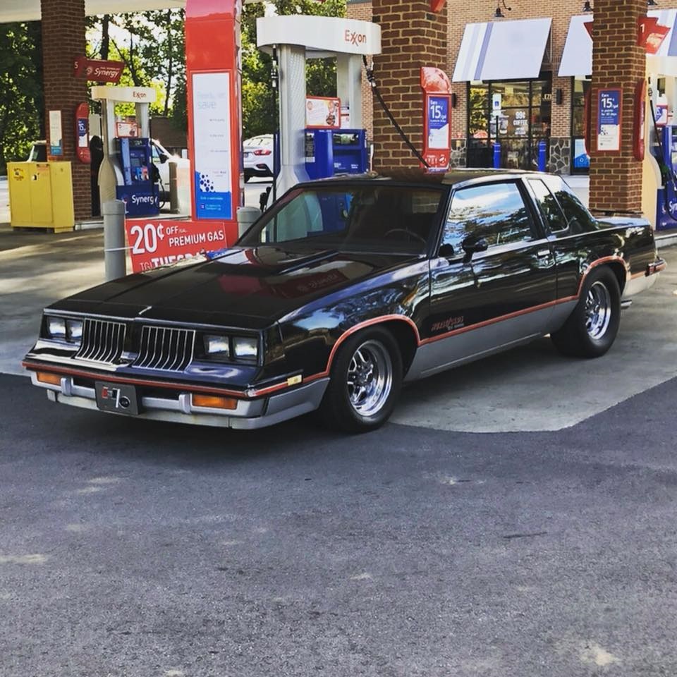 1983 oldsmobile hurst/olds at a gas station