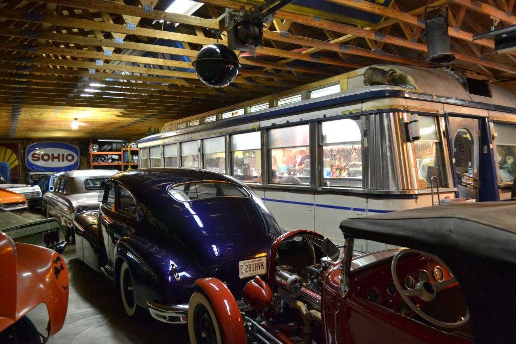 old cars and a bus in a shop museum