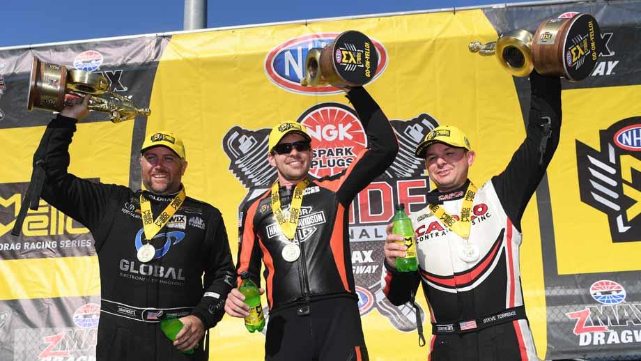 nhra winners holding trophies