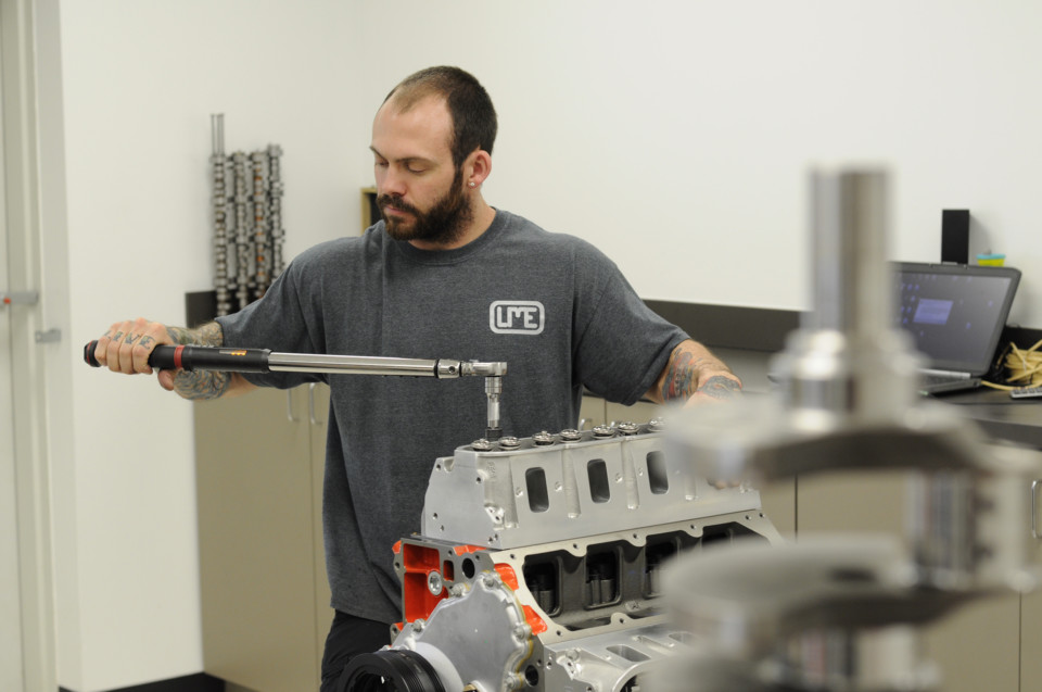 man torqueing down cylinder head bolts