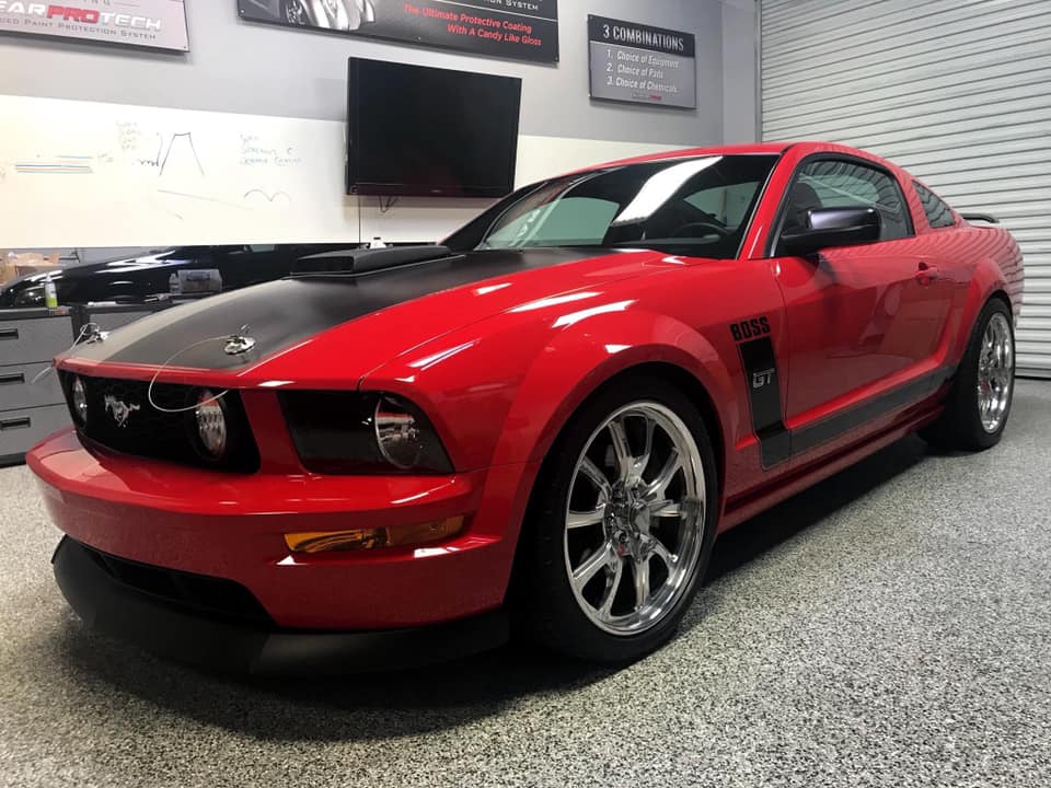 2007 ford mustang gt in garage with hood pins