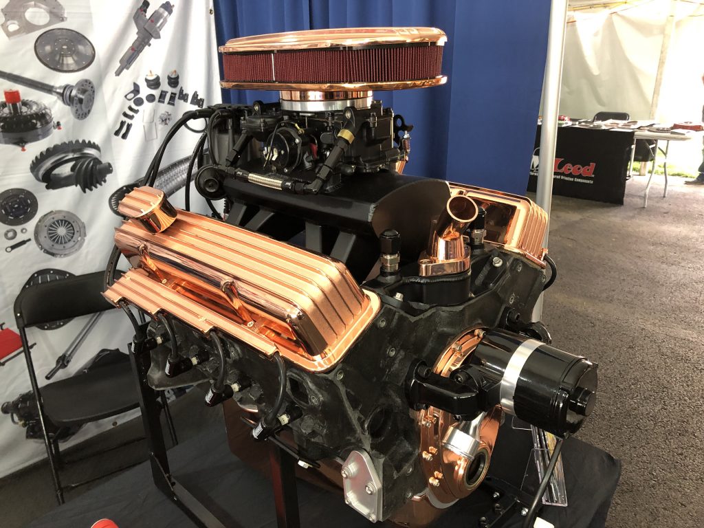an engine dressed up with copper valve covers, air cleaner, and accent pieces