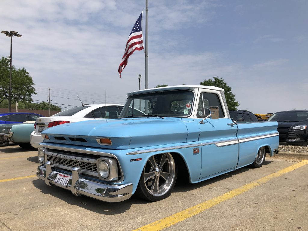 1964 chevy c10 pickup truck with american flag in background at summit racing