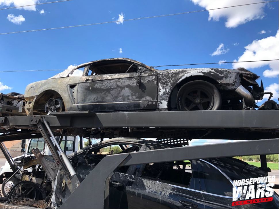 fire damaged ford mustang on a trailer