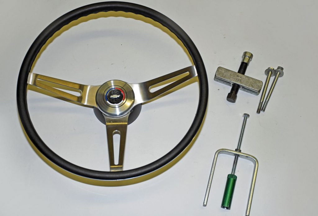 chevy steering wheel on workbench next to install tools