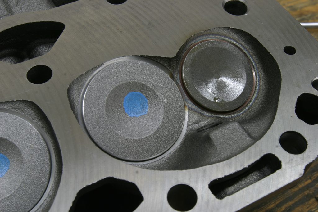 close up of a combustion chamber and valves on an engine cylinder head