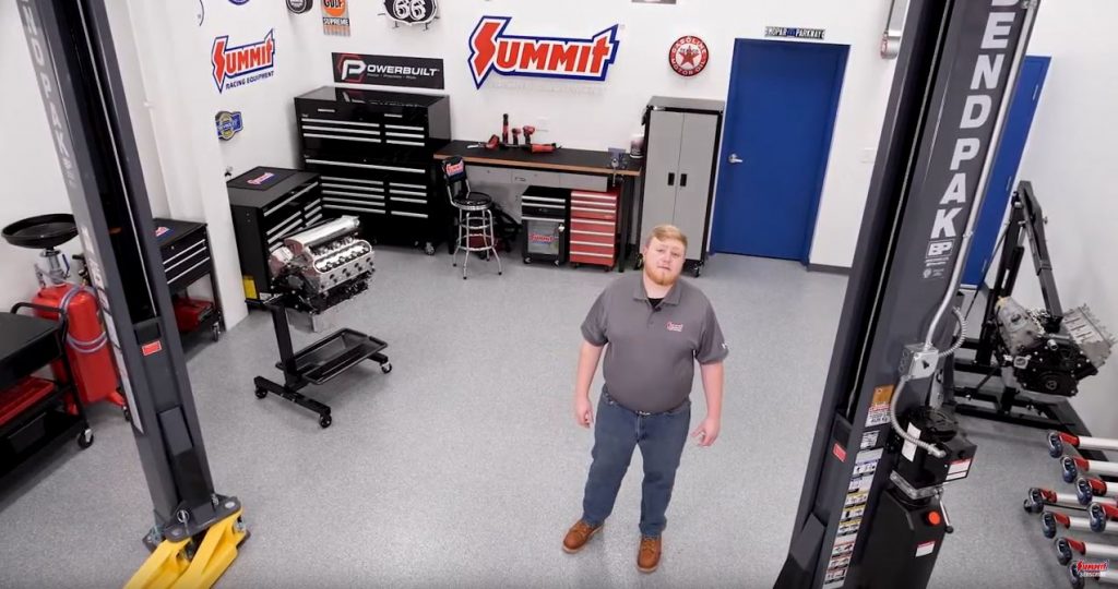 man standing in summit racing's project build video studio garage