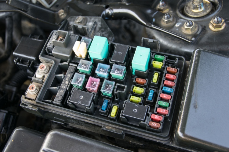 close up of a car's electrical fuse relay box