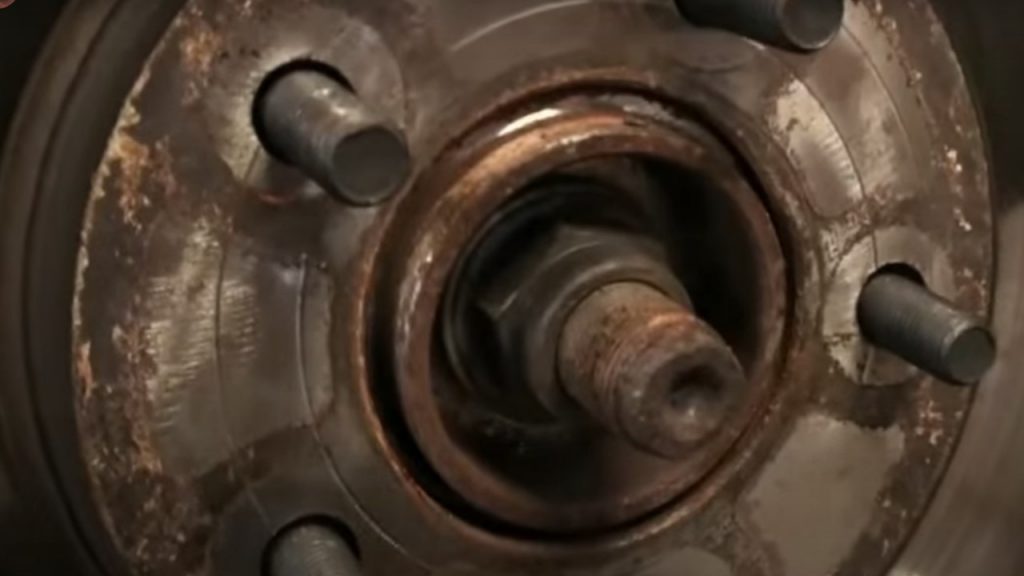 close up of a dirty rusty brake rotor hub
