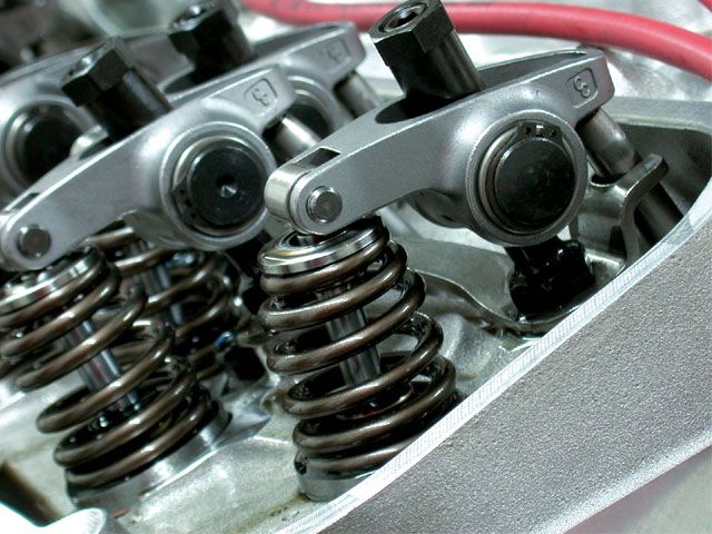 a close up of rocker and valve spring on a cylinder head