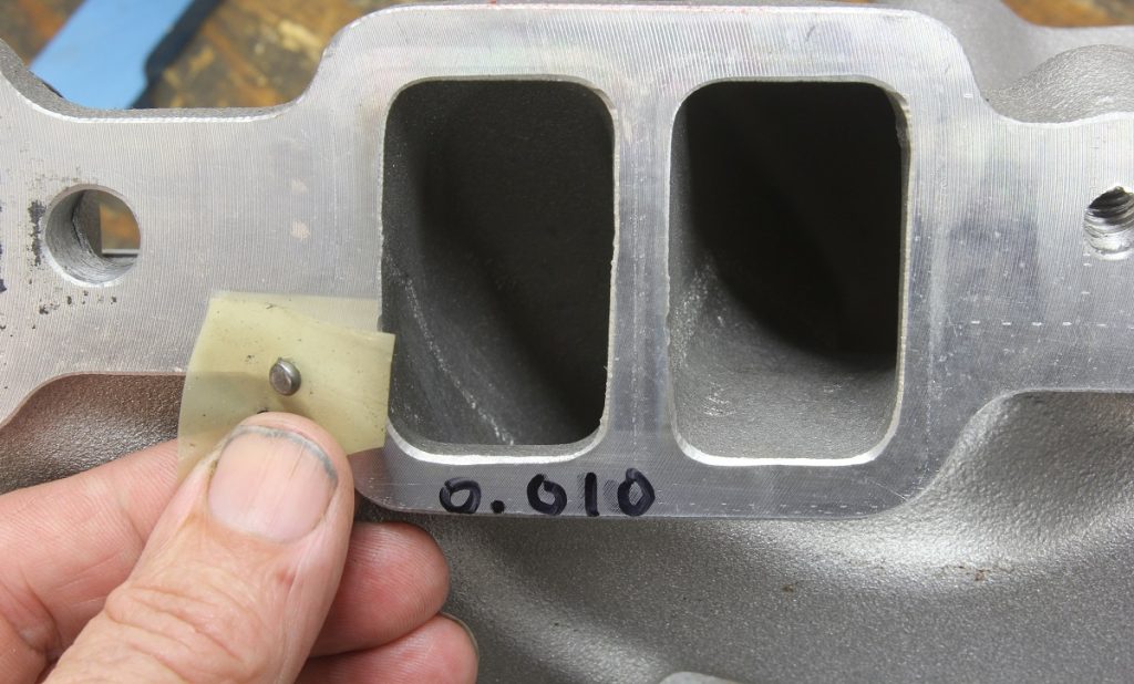 a close up of mounting flange on a small block chevy exhaust manifold